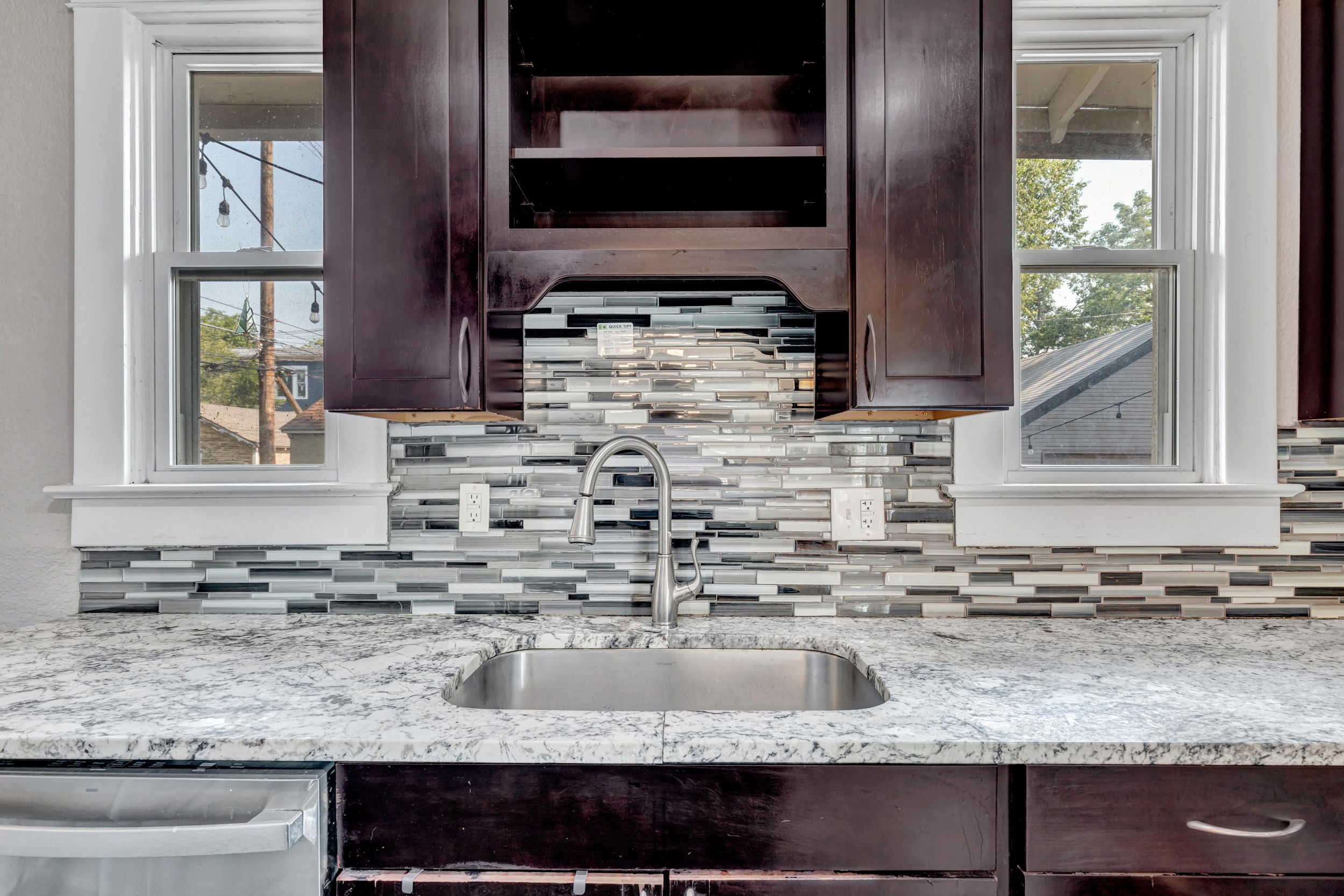 Kitchen sink with glass-tile backsplash