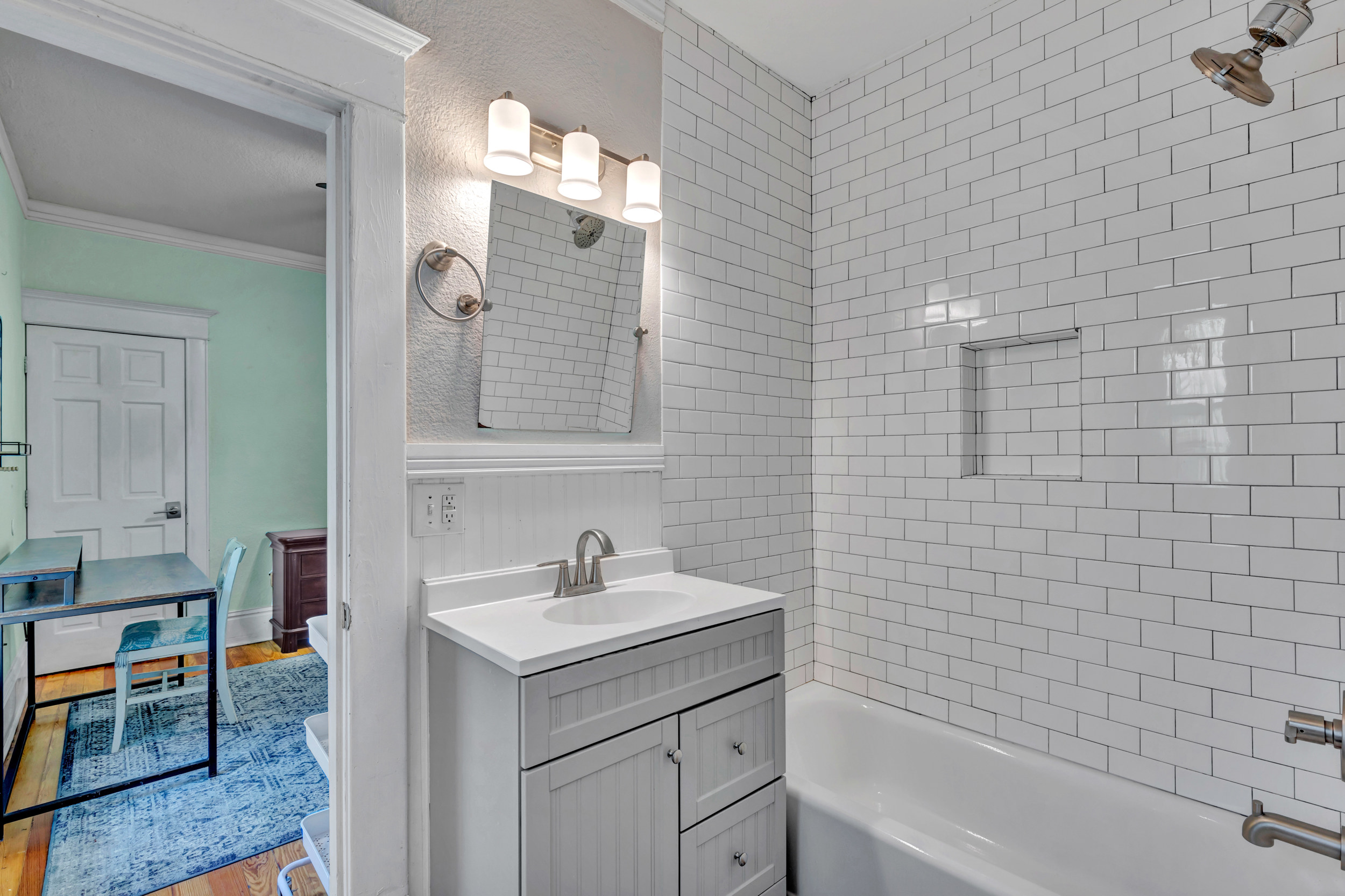 Full bathroom with white subway tile tub and shower