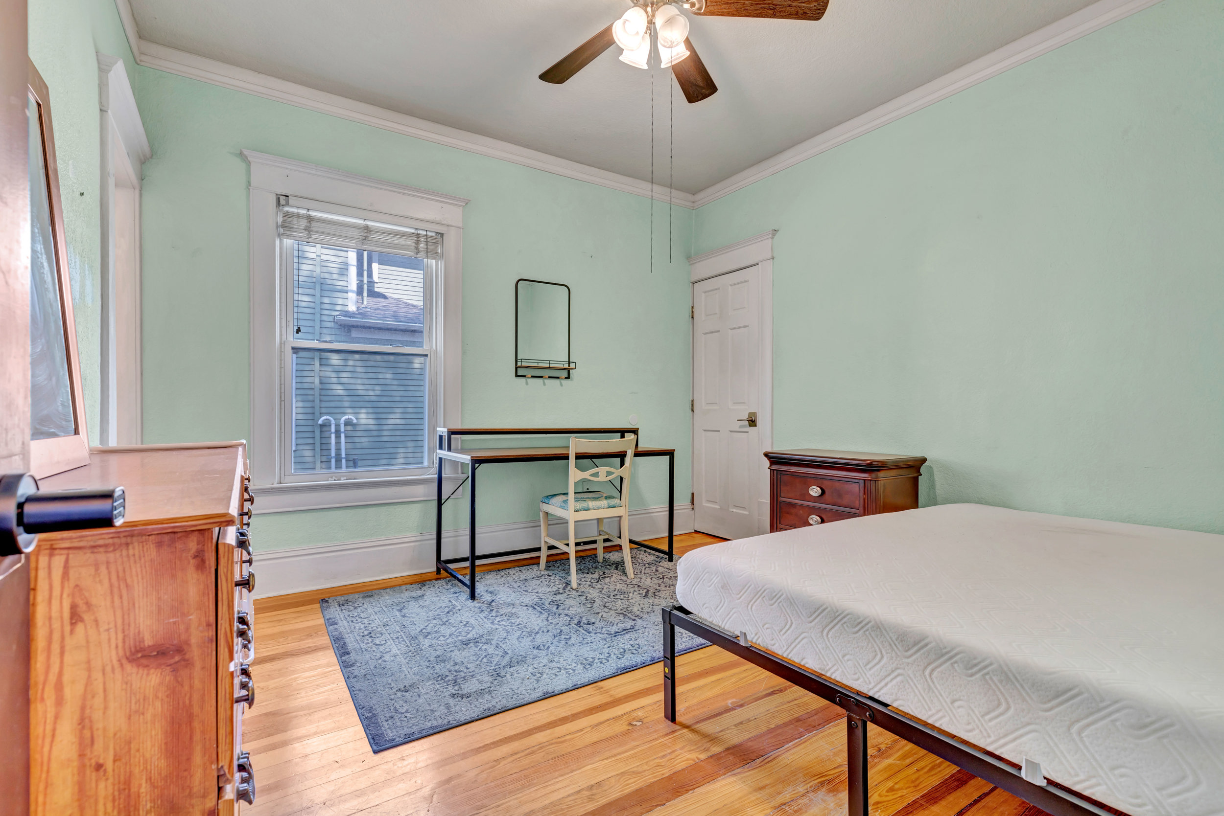 Bright furnished bedroom with study desk