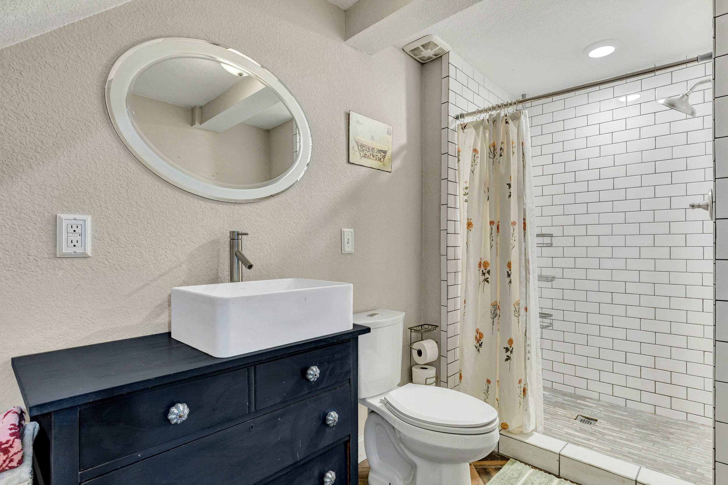 Second full bathroom with vessel sink and tiled shower