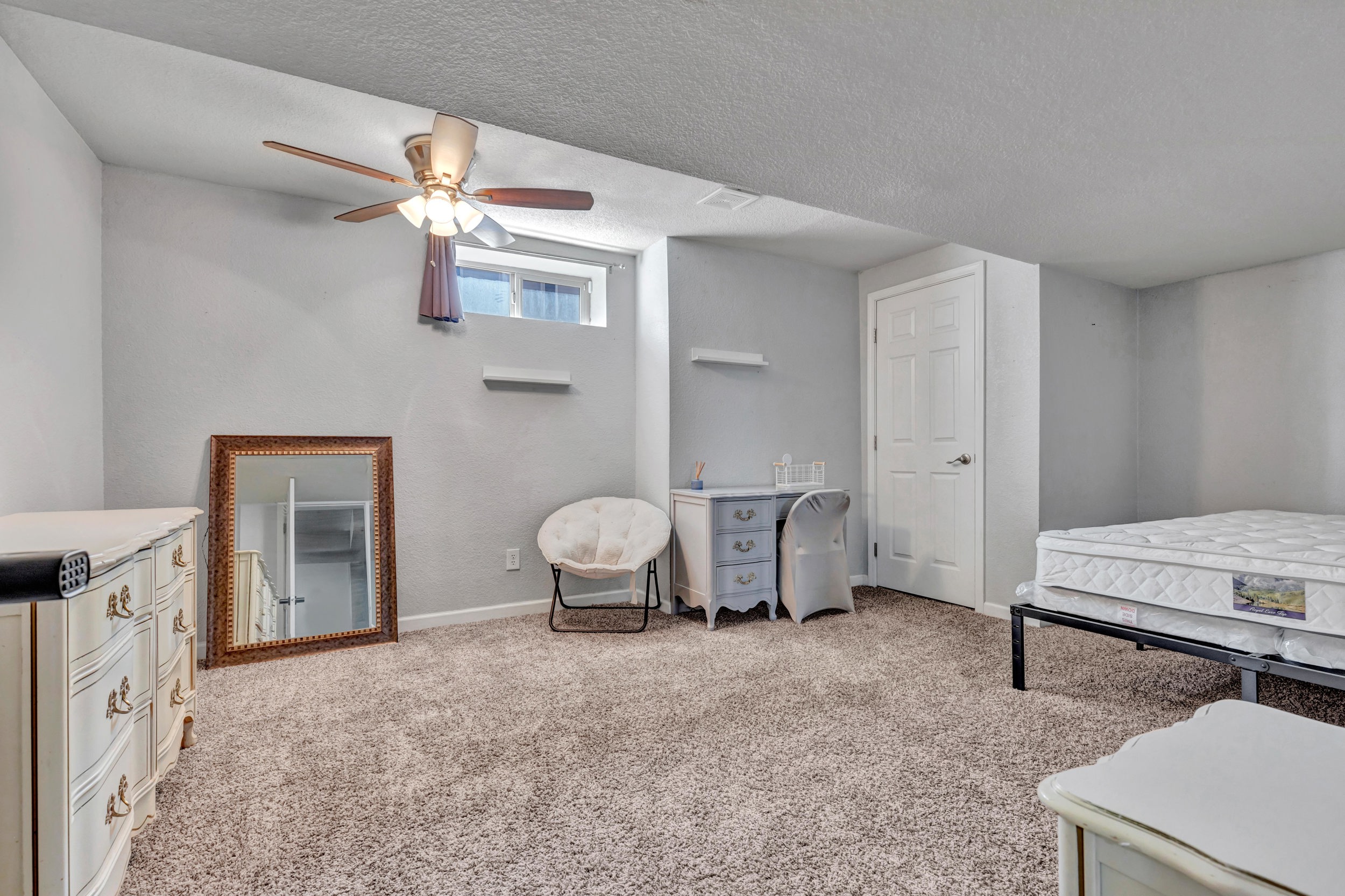 Spacious carpeted lower-level bedroom