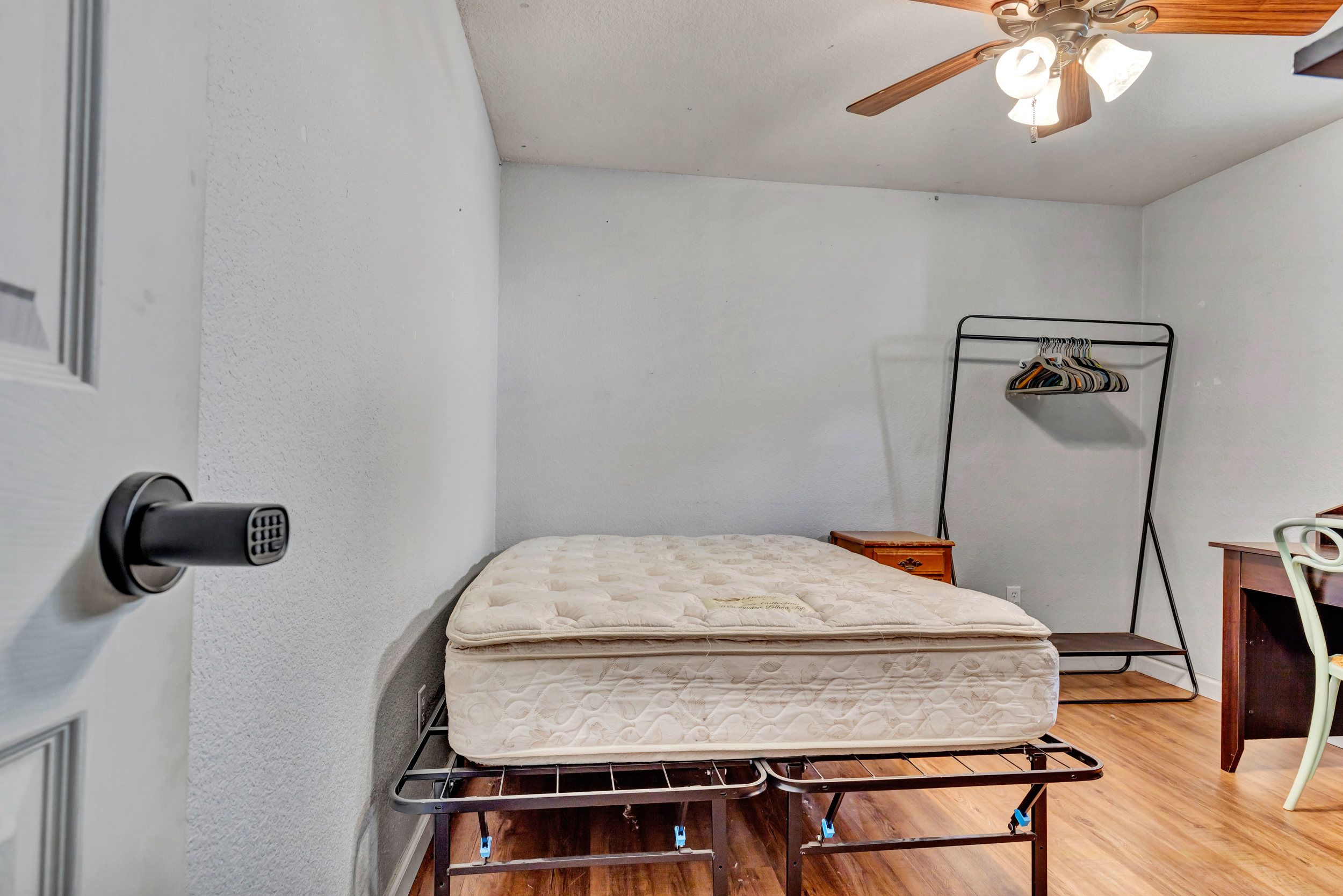 Furnished bedroom with keyless lock and desk