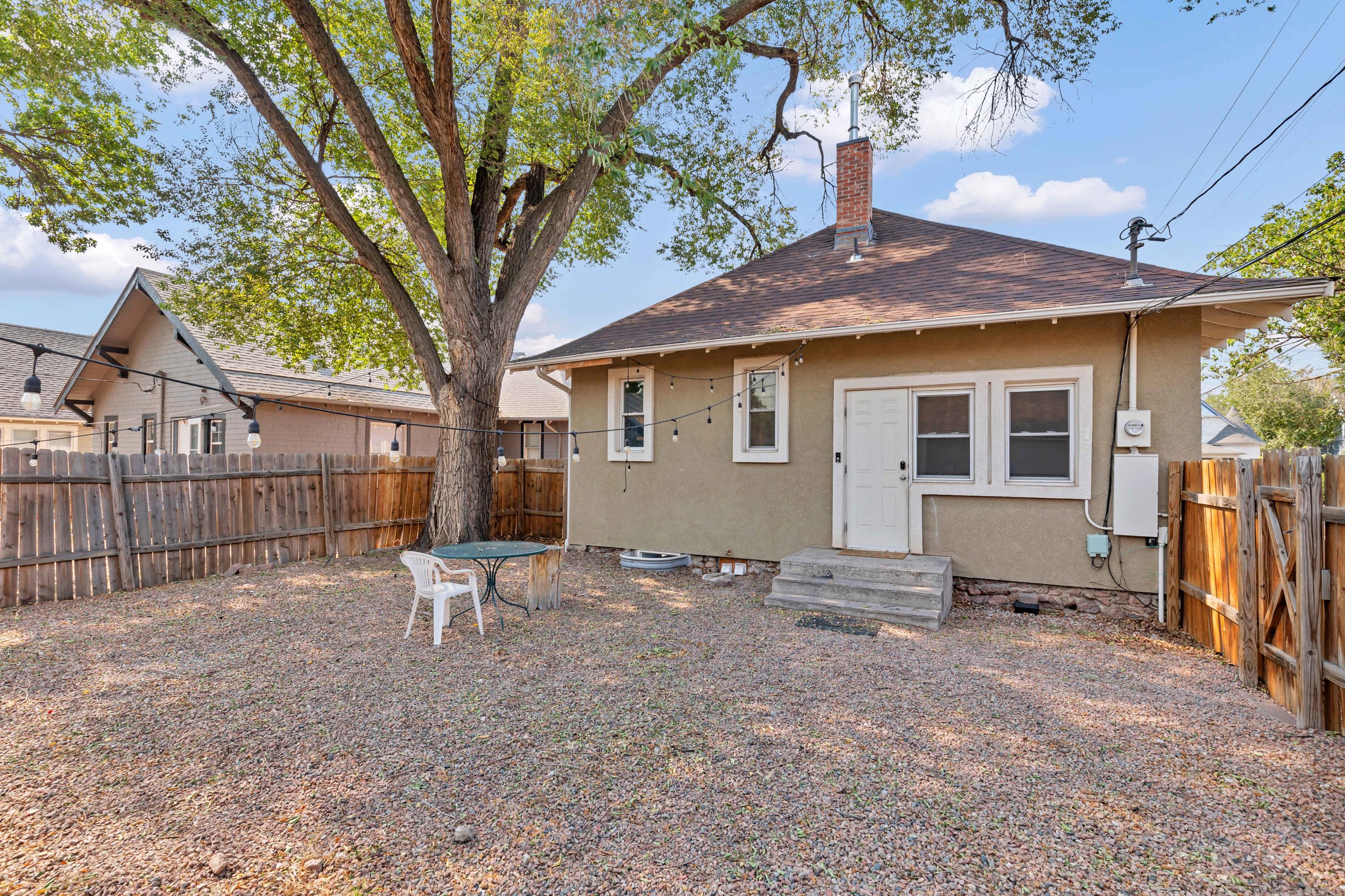 Private backyard shaded by a mature tree