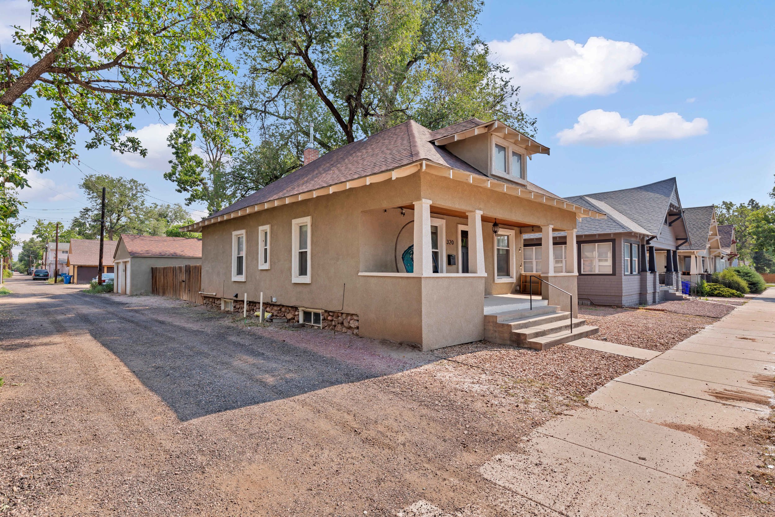 Street view with detached garage behind