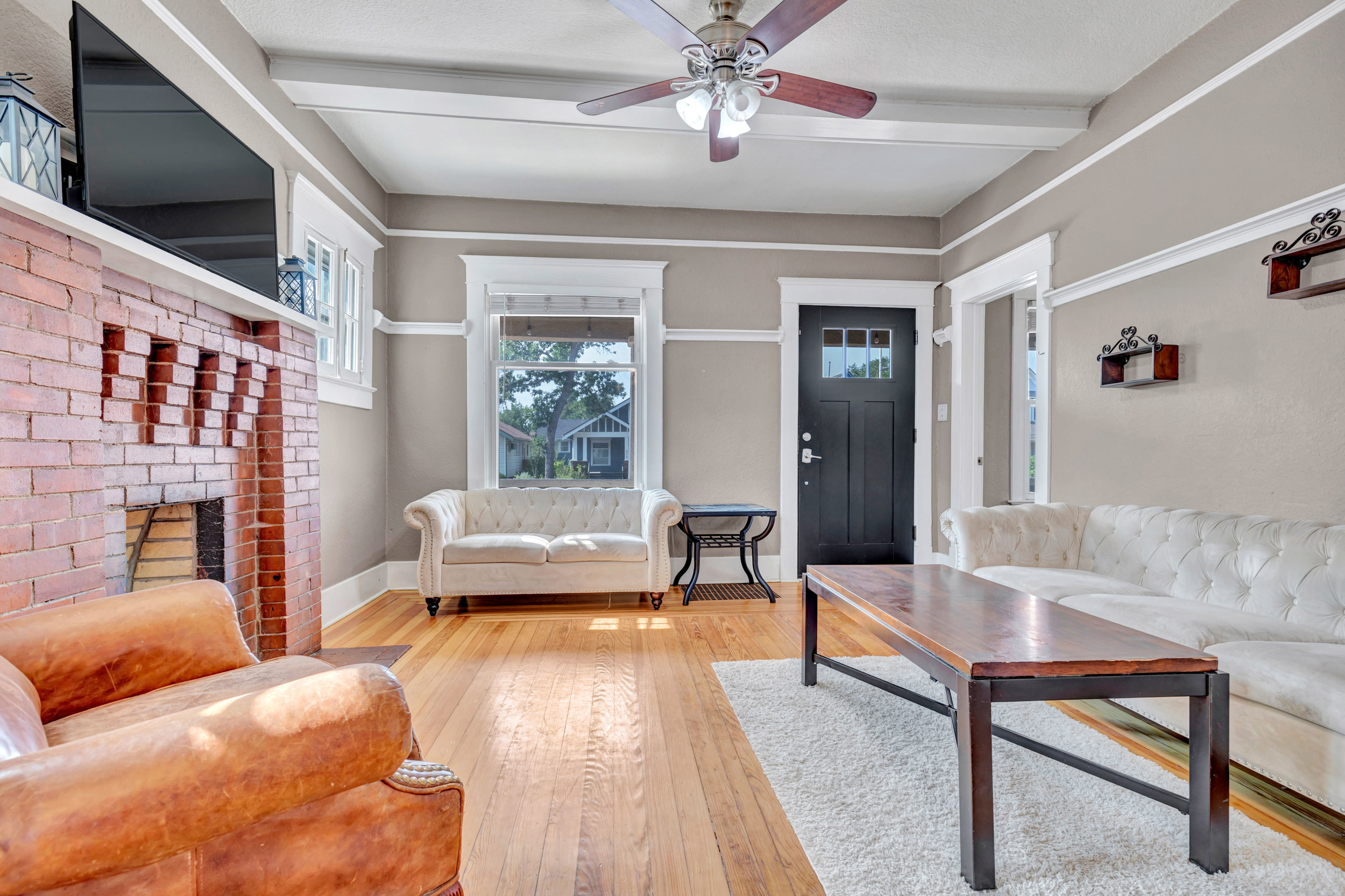 Living room with original brick fireplace